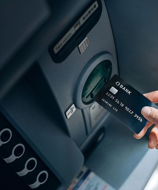una tarjeta de crédito introduciéndose en la ranura de un cajero automático